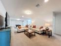 Spacious Gathering room with neutral carpeting and comfortable seating at 8829 Corcovado Dr, Kissimmee, FL 34747