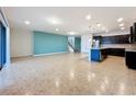 Open concept living room and kitchen with tile floors and an accent wall at 8829 Corcovado Dr, Kissimmee, FL 34747