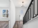 Bright entryway with modern staircase and hardwood floors at 2122 Whitney Marsh Aly, Orlando, FL 32804