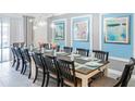 Large dining room with a long table and blue accent wall at 2965 Protagonist St, Kissimmee, FL 34746