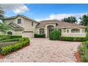 Two story home with a large driveway and landscaped yard at 1125 English Garden Se Ln, Winter Garden, FL 34787