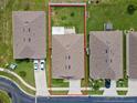 Aerial view of a single-Gathering house with a backyard and driveway at 5716 Lakeside Landings Blvd, Winter Haven, FL 33881