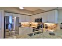 Modern kitchen with stainless steel appliances and granite countertops at 5300 S Atlantic Ave # 16-602, New Smyrna Beach, FL 32169