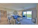 Bright living room with comfy seating, large windows and access to balcony at 5300 S Atlantic Ave # 16-602, New Smyrna Beach, FL 32169
