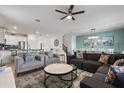 Spacious living room with comfy sofas, large windows, and a ceiling fan at 9106 Sommerset Hills Dr, Davenport, FL 33896