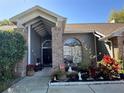 Front entryway with brick columns and landscaping at 1046 Shinnecock Hills Dr, Oviedo, FL 32765