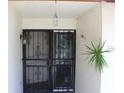Inviting front entrance with security gate and mature plant at 2681 Washington Ave # 18, Eustis, FL 32726