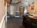 Living room with dark wood flooring, a rocking chair, and access to other rooms at 126 Mason St, Auburndale, FL 33823