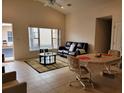 Spacious living room with tile floors, brown leather couch, and dining area at 332 David Walker Dr # J-2, Tavares, FL 32778