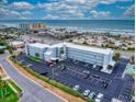 Oceanfront property aerial view showing building, parking, and beach at 3700 S Atlantic Ave # 407, New Smyrna Beach, FL 32169