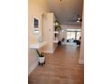 Light and airy entryway with tile floors, floating shelves, and mirror at 2019 Jaffa Ct, Clermont, FL 34714