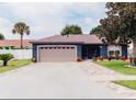 Well-maintained home exterior with a two-car garage and landscaping at 2019 Jaffa Ct, Clermont, FL 34714