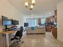 Living room with open floor plan, modern furniture, and home office setup at 13880 Arclid St, Orlando, FL 32832