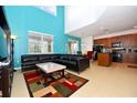 Living room with sectional sofa and high ceilings at 401 Cabello Dr, Davenport, FL 33837