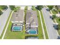 Aerial view of two houses with private pools in a residential area at 2669 Santosh Cv, Kissimmee, FL 34746