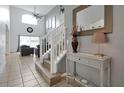 Bright entryway with staircase, console table, and mirror at 112 Paloma Dr, Davenport, FL 33837