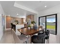 Modern kitchen with island, dining area, and access to backyard at 6230 Chorus Dr, Mascotte, FL 34753