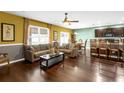 Open living room with hardwood floors and a view of the kitchen at 205 Hamlet Rd, Davenport, FL 33837