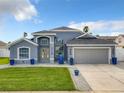 Two-story house with gray exterior and two-car garage at 310 Ballyshannon Dr, Davenport, FL 33897
