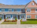 Two-story townhouses with a charming white picket fence and colorful landscaping at 2213 San Vittorino Cir # 106, Kissimmee, FL 34741