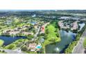 Aerial view highlighting condo location near golf course and lake at 14037 Fairway Island Dr # 233, Orlando, FL 32837