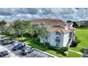 Exterior view of condo building with parking and landscaping at 14037 Fairway Island Dr # 233, Orlando, FL 32837