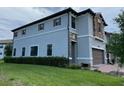 Side view of a two-story townhome, showcasing its stone and stucco exterior at 8502 Arcadia Ln, Davenport, FL 33896