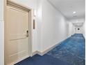 Building hallway with carpeted floors and neutral walls at 14501 Grove Resort Ave # 3229, Winter Garden, FL 34787