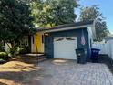 Charming home with yellow front door and attached garage at 1848 Mizell Ave, Winter Park, FL 32789