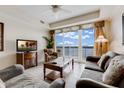 Living room with lake view and comfy furniture at 13427 Blue Heron Beach Dr # 1004, Orlando, FL 32821