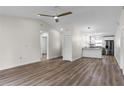 Open living room with new flooring, high ceilings, and kitchen access at 137 Birmingham Dr, Kissimmee, FL 34758