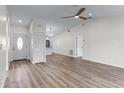Open living room with new flooring, high ceilings, and kitchen access at 137 Birmingham Dr, Kissimmee, FL 34758