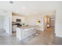 Modern kitchen with island, stainless steel appliances, and tile flooring at 1145 Brimstone Cir, Winter Haven, FL 33884