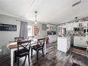 Open concept kitchen with white cabinets, island, and dining area at 22545 Orange Blossom Ln, Eustis, FL 32736