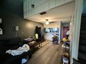 Open living room and kitchen area with laminate flooring at 34 Saint Andrews Ct, Kissimmee, FL 34759