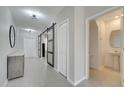 Bright foyer with tile floors, a half bathroom, and sliding barn door at 552 Silver Palm Dr, Haines City, FL 33844