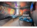 bedroom with Star Wars mural, two twin beds, and a TV at 9101 El Caro Ln, Davenport, FL 33896