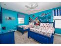 bedroom with Finding Nemo mural, two twin beds and blue accents at 9101 El Caro Ln, Davenport, FL 33896