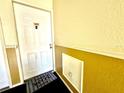 Interior condo entryway with a door and welcome mat at 3970 Versailles Dr # 3970B, Orlando, FL 32808