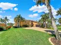 Beautiful two-story house with lush landscaping at 102 Via Duomo, New Smyrna Beach, FL 32169