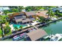 Waterfront property featuring a pool, dock, and boat slips at 102 Via Duomo, New Smyrna Beach, FL 32169