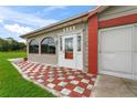 House entrance with red and white checkered tile at 636 Koala Ct, Poinciana, FL 34759
