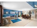 Open living and dining area with blue accent wall and modern furniture at 3227 Shingler Ter, Deltona, FL 32738