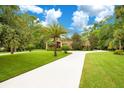 Landscaped front yard with circular driveway leading to a stunning brick home at 2083 Biltmore Pt, Longwood, FL 32779