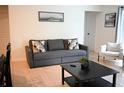 Bright living room featuring a comfortable sofa and coffee table at 605 Oakpoint Cir, Davenport, FL 33837