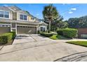 Two-story townhome with a two-car garage and manicured landscaping at 400 Harbor Winds Ct, Winter Springs, FL 32708