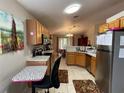 Kitchen with wood cabinets and stainless steel appliances at 185 Winding Cove Ave, Apopka, FL 32703