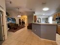 Open living room with tile floors and comfortable furniture at 185 Winding Cove Ave, Apopka, FL 32703