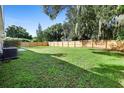 Large backyard with grassy area and wooden fence at 2026 Travelers Palm Dr, Edgewater, FL 32141