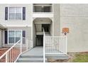 Exterior view of condo building with a staircase and ramp at 3174 Feltrim Pl # 104, Kissimmee, FL 34747